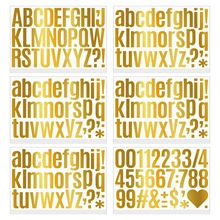 Macro detail of 6 sheets of gold waterproof vinyl letter and number stickers for mailboxes
