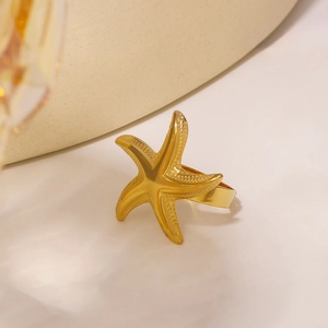 Elegant gold starfish napkin ring made of premium metal for luxury ocean themed table decor