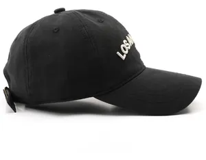 Detailed side view of black cotton baseball cap with 3D white letter embroidery