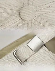 Detail of beige cotton baseball cap featuring metal buckle and premium radial stitching
