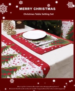 Close-up of red Christmas table runner and placemats with festive tree patterns