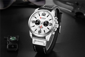 Detailed close-up of CURREN men's chronograph watch with white dial and black leather strap