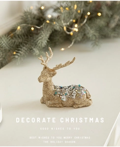 Detail of golden Christmas reindeer ornament with glitter sequins and festive decor