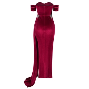 Detail of burgundy velvet evening gown featuring a side slit and sparkling rhinestone fringe