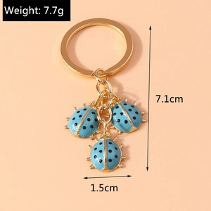 Golden keychain with blue ladybug charms featuring dimensions 7.1cm height and 7.7g weight