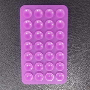 Detail of purple square silicone suction pad with 28 semi-transparent pop-up bubbles