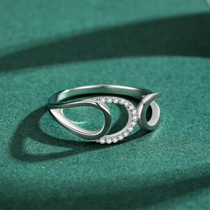 Minimalist S925 sterling silver geometric ring with cubic zirconia on a green background