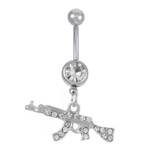 Detail of silver belly ring with AK-47 rifle pendant and sparkly zircon crystals