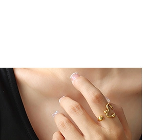 Detail shot of a minimalist gold irregular lava ring worn by a model in a luxury style
