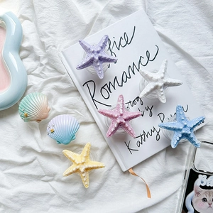 Detailed close-up of colorful resin starfish and shell magnetic phone grip accessories