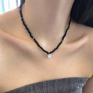 Detail of S925 silver heart pendant on a luxury black crystal beaded necklace for women