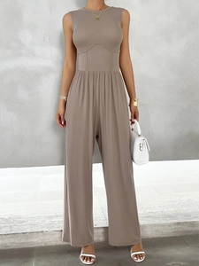 Detail view of khaki sleeveless wide-leg jumpsuit showing ribbed texture and cinched waist