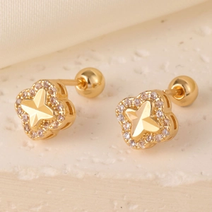 Macro detail of gold star clover stud earrings with zirconia and screw ball backs