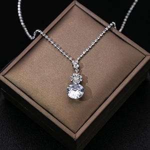 Macro detail of a silver zircon pendant with a large crystal stone in a brown gift box