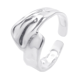 Macro shot of silver titanium ring with irregular lava texture and open adjustable band