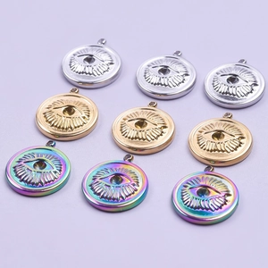 Evil eye stainless steel pendants in gold, silver, and rainbow finishes on purple background