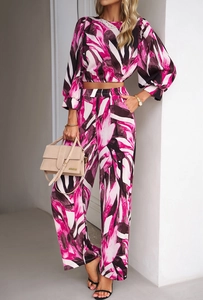 Detail shot of the abstract leaf pattern on this pink and dark two-piece fashion set