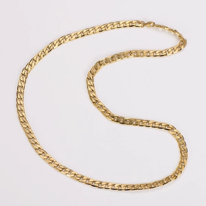 Close-up of golden Figaro chain necklace with polished flat links and metallic luster