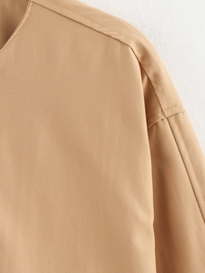 Detail shot of khaki bomber jacket shoulder with durable double-stitched seams