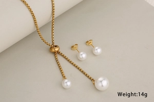 Detail shot of a golden stainless steel pearl jewelry set with necklace and earrings