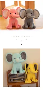 Detail showing four colorful plush elephant dolls in pink, gray, blue and yellow soft fabric