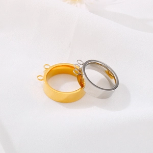 Gold and silver stainless steel rings with three attachment loops on white fabric