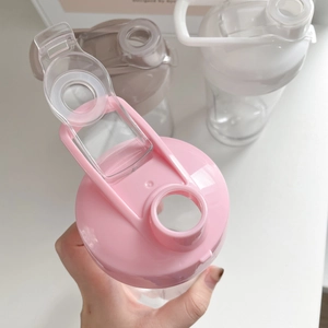 Pink, beige, and white macaron colored sports water bottles with flip lids and handles