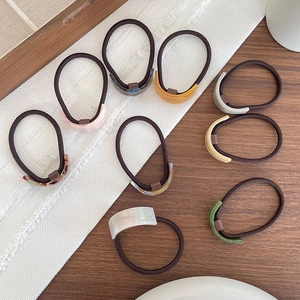 Set of eight acetate hair ties with minimalist curved designs in various stylish colors