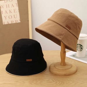 Detailed view of cotton canvas bucket hat side logo with clean stitching in black and khaki