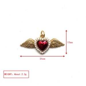 Detail view of 17mm x 31mm golden winged heart pendant with red stone and dimensions