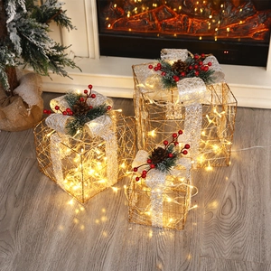 Three-piece glowing Christmas gift boxes with warm LED lights and pine cone accents