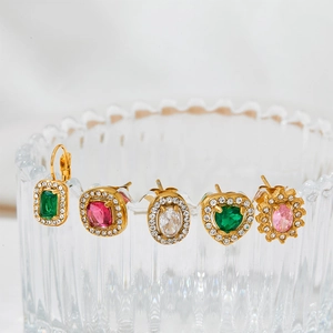 Elegant gold earrings with emerald green crystals and white diamond halo settings