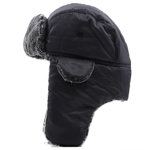 Detail of winter trapper hat with black waterproof shell and thick gray faux fur lining