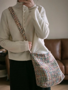 Close-up of the colorful knitted shoulder bag with textured weave and wide strap