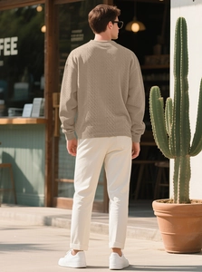 Detail of khaki cable knit sweater showing textured weave and dropped shoulder fit