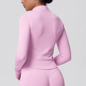 Detailed back view of pink athletic yoga top featuring vertical rib-knit texture and stand collar