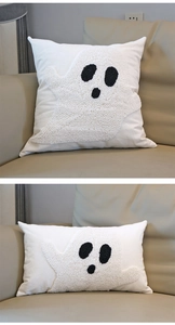 Detailed close-up of a white tufted ghost pattern on a soft festive throw pillow cover