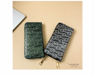 Detail of embossed PU leather women's long wallet with chain pattern and gold zipper