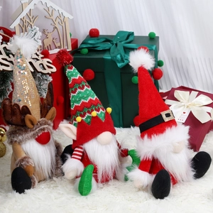Three Christmas gnomes plush set with reindeer and elf designs on white carpet