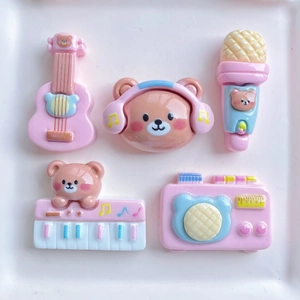 Detailed view of 5-piece pink and blue resin cartoon music bear accessories on a tray