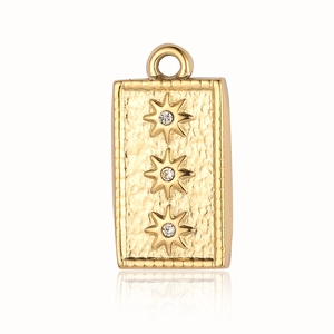 Detailed view of gold rectangle pendant with hammered texture and star stone settings