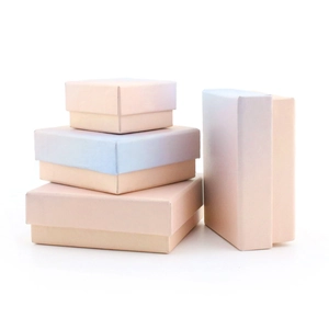 Pink and blue gradient jewelry gift boxes in square and rectangular shapes on white backdrop