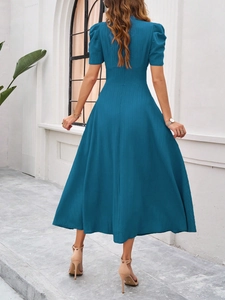 Back view of elegant blue V-neck dress with textured stripes and slim high waist