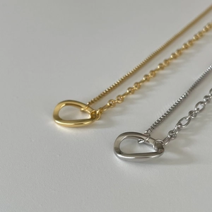 Detailed view of 925 sterling silver gold and silver drop pendants on box chains