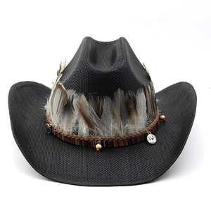 Detail of woven straw cowboy hat featuring natural feathers and ethnic beaded trim
