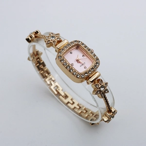 Detailed side view of a gold square quartz watch featuring a sparkling flower crystal bracelet
