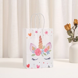 Unicorn kraft paper gift bag with gold stamping and floral patterns on warm white background
