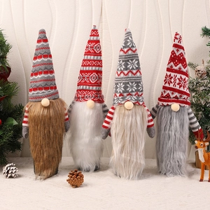 Detailed view of four Christmas gnome wine bottle covers with knitted hats and plush beards