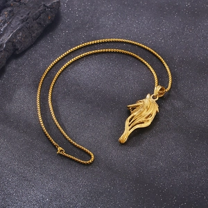 Detailed close-up of a golden Viking wolf head pendant on a premium box chain