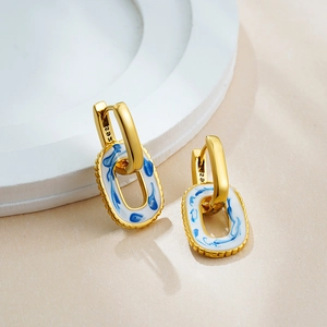Detail of 18K gold S925 hallmark on blue and white enamel oval hoop earrings